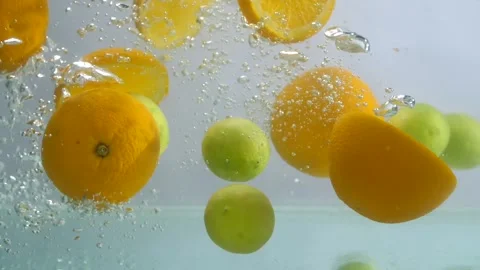 A bunch of a few oranges and lemons dropping in clear freshwater - healthy fr... Stock Footage 157573997