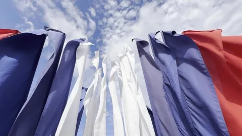A bunch of flags are hanging in the air, with some red, white, and blue Video stock 277561089