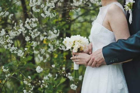 Bunch of flowers in hands  Stock Photos