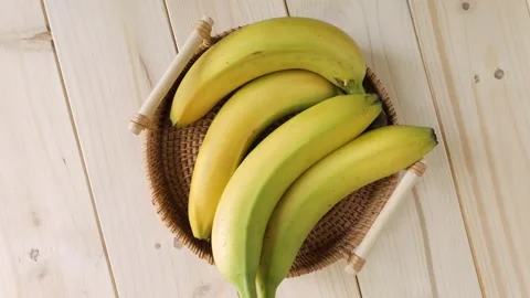 Bunch of fresh bananas rotating in a wicker basket Stock Footage 339366907