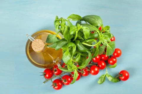 Bunch of fresh basil, tomatoes and olive oil - traditional ingredient of ital Stock Photos