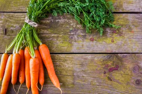 Bunch of fresh carrots on a rustic background Stock-Fotos