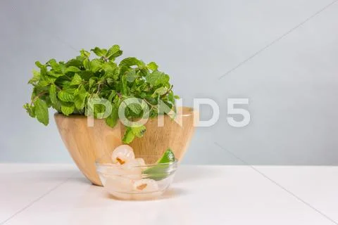 Bunch Of Fresh Green Basil In Wooden Bowl
