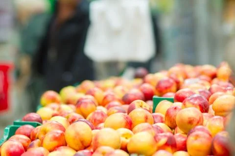 Bunch of fresh red nectarines in boxes in supermarket Stock Photos