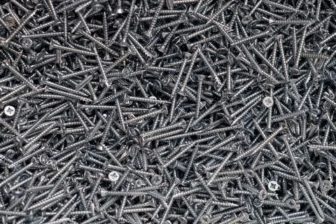 Bunch of galvanized stainless screws with flat countersink head, hardware bac Foto stock