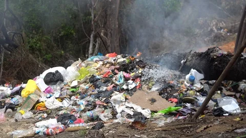 A bunch of garbage is burning. smolders waste in a landfill Stock Footage 127047148
