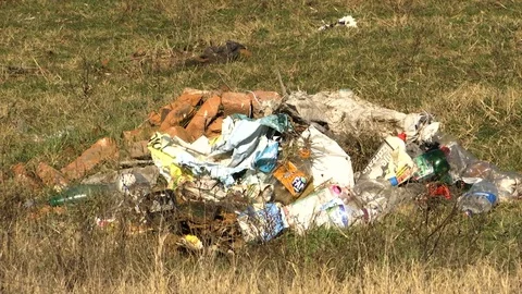 A bunch of garbage on the grass Stock Footage 82697570