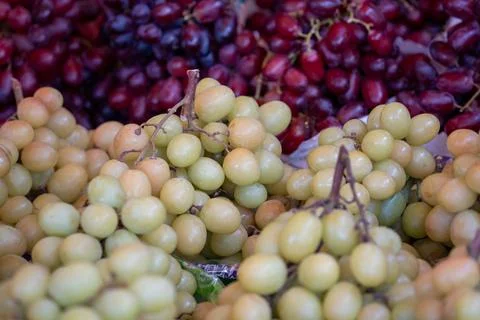 A bunch of grapes are displayed in a store Stock Photos