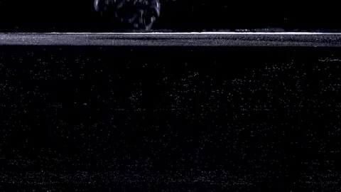 Bunch of grapes falling into water in slow motion. Isolated on black background Stockbeeldmateriaal 124832989