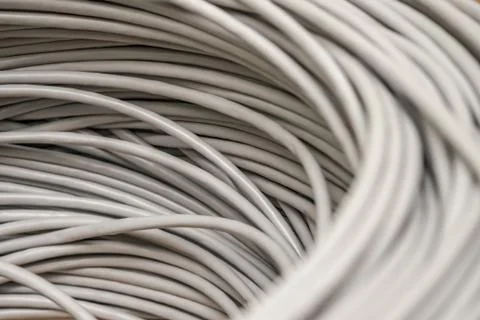 Bunch of gray Unshielded twisted pair cables is a close-up. Abstract technolo Stock Photos
