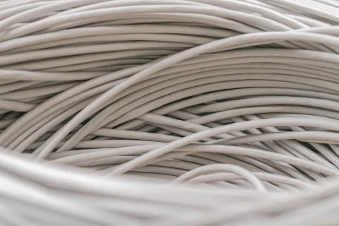 Bunch of gray Unshielded twisted pair cables is a close-up. Abstract technolo 库存照片