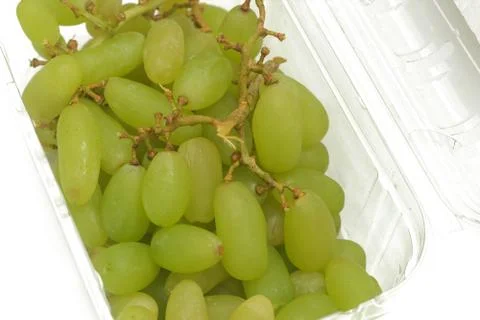 A bunch of green grape in a transparent case Stock Photos