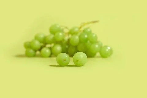 A bunch of green grapes on a colored background. Space for text Stock Photos