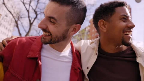 Bunch of happy multirracial friends having fun outdoors at the park. Looking at Stock Footage 246608151