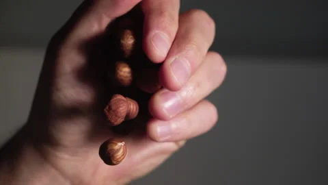 A bunch of hazelnuts falling from hand Stock Footage 152383602