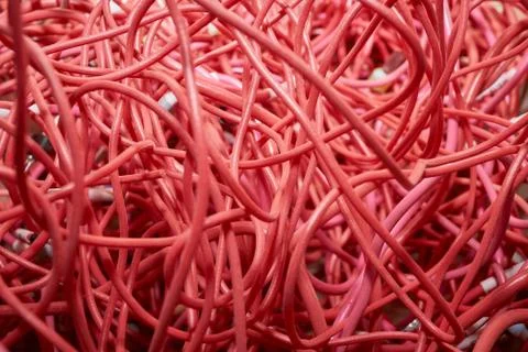 A bunch of highly entangled red electrical wires. Stock Photos