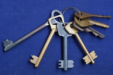 Bunch of keys on a blue background. Stock Photos