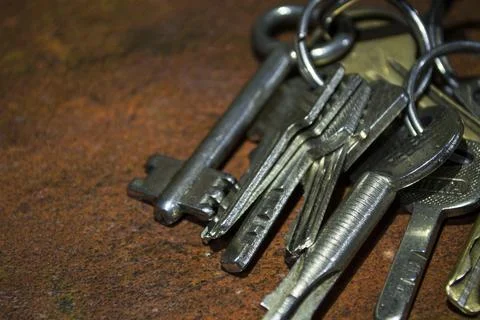 A bunch of keys on a brown background. Stock Photos