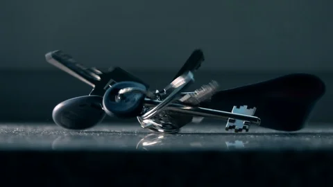 Bunch of keys falls down on the table, slow motion shot Stock Footage 114177539