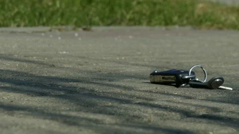 Bunch of keys lying lost on pavement Stock Footage 152092474
