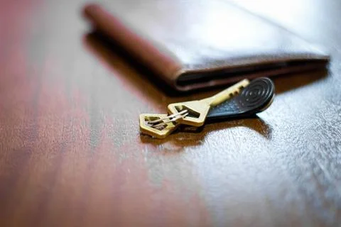 A bunch of keys lying on the table next to the documents. Stock Photos