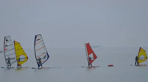 A bunch of Kids learning to Windsurf off the Barcelona cost. Vídeos de archivo 60701404