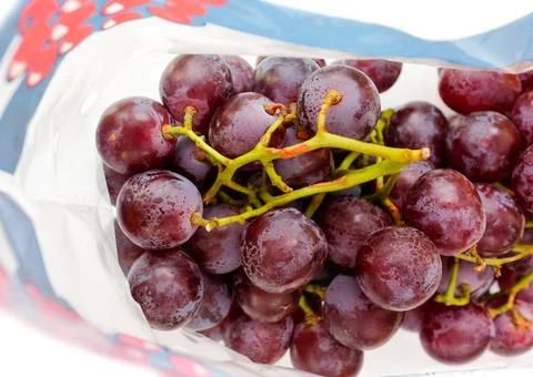 A bunch of large grapes in a package Stock Photos