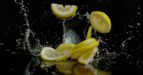 Bunch of lemon slices splash on black background super slow motion Video stock 249562837