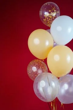 A bunch of light balloons on a red background. Vertical Photo Space for Text Stock Photos