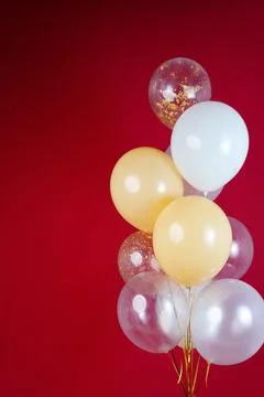 A bunch of light balloons on a red background. Vertical Photo Space for Text Stock Photos