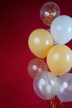 A bunch of light balloons on a red background. Vertical Photo Space for Text Foto stock