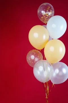 A bunch of light balloons on a red background. Vertical Photo Space for Text Stock Photos