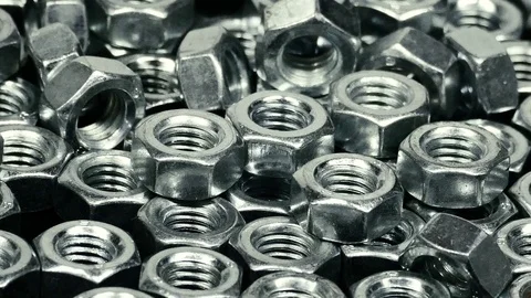 Bunch of metal nuts rotating, closeup Stock Footage 72762223