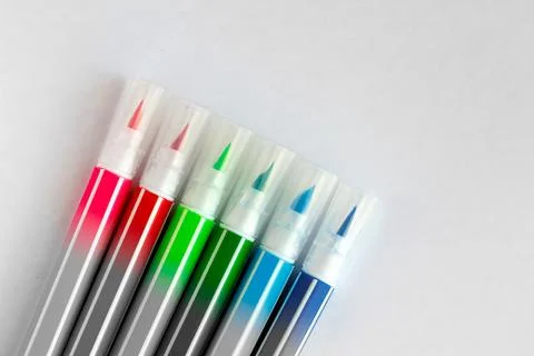 Bunch of multi-colored felt pens on white blank sheet of paper Stock Photos