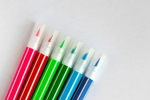 Bunch of multi-colored felt pens on white blank sheet of paper Stock Photos