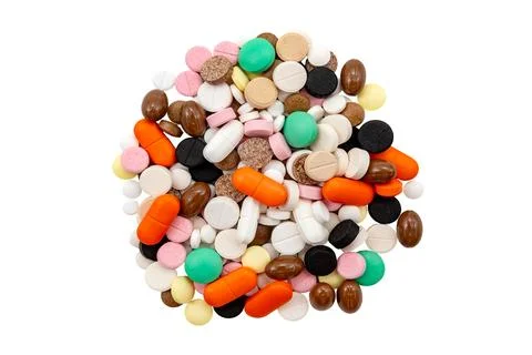 A bunch of multi-colored tablets and capsules on a white background. Health.. Stock-Fotos