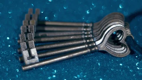 Bunch of old iron keys on a blurred background. Closeup. Macro Stock Footage 297756674