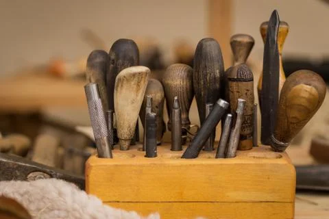 Bunch of old shoemaker tools in leather craft workshop Stock Photos