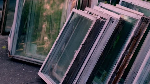 Bunch of old wooden windows frames on the street. Replacement of windows Stock Footage 246423086