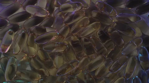 A bunch of Omega Fish Oil tablets or capsules slowly rotate in multi-colored Stock Footage 235457901