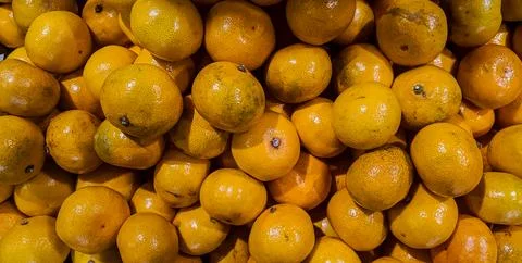 A bunch of oranges are piled up on top of each other. Stock Photos
