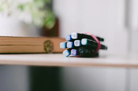 A bunch of pens are on a table Stock Photos