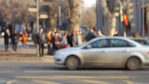 A bunch of people out of focus traversed the road in front of the camera Stock Footage 80576475