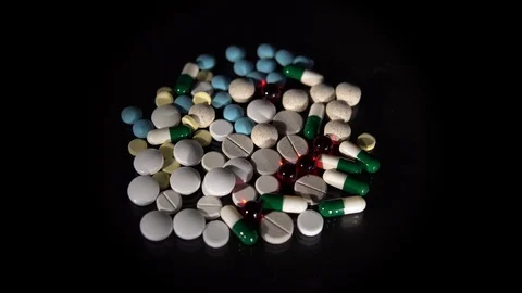 A bunch of pills on a black background Stock Footage 118543145
