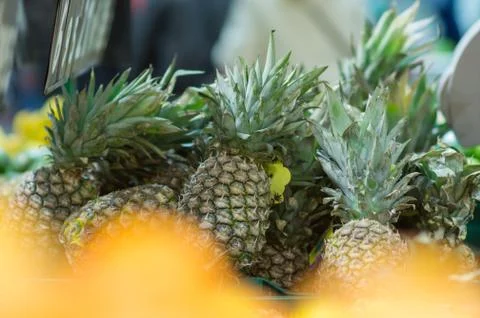 Bunch of pineapples in boxes in supermarket Stock Photos