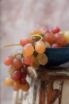 Bunch of pink grapes over rustic background Stock Photos