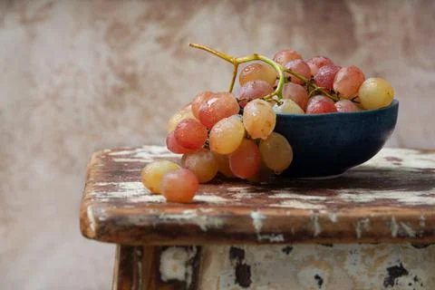 Bunch of pink grapes over rustic background Stock Photos