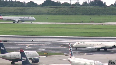 Bunch of planes passing one another on the runway at airport Stock Footage 84515135
