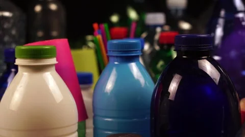 Bunch of Plastic Bottles, Cups and Straws on Table, Close Up Stock Footage 301276908