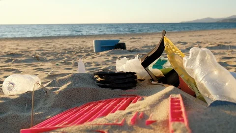 Bunch of Plastic Garbage on sandy beach sunset time,polluted nature ecosystem Video stock 128149471